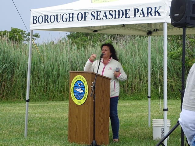 A woman stands at a podium